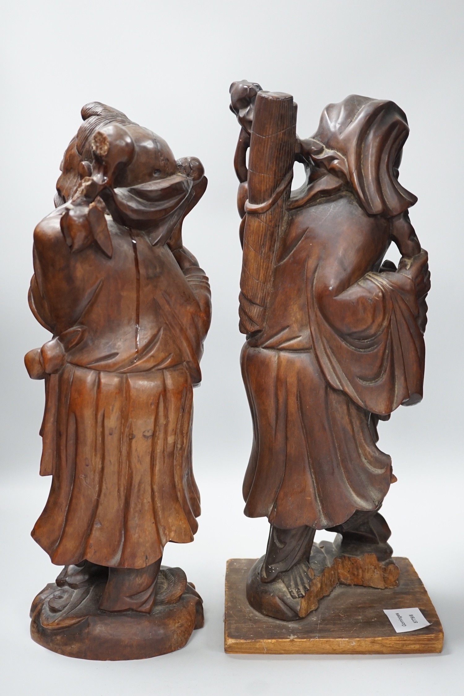 Two Chinese hardwood figures of luohans, early 20th century Tallest 48cm